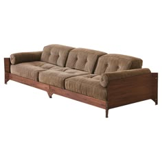 a brown couch sitting on top of a wooden frame