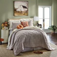 a bedroom with green walls and white furniture