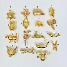 a bunch of gold colored metal items on a white surface with numbers in the middle