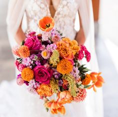 a bride holding a bouquet of flowers in her hands