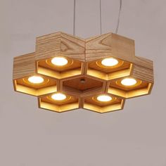 a wooden light fixture with four lights on each side and five square ones in the middle