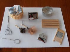 various items are laid out on a white tablecloth, including scissors and other crafting supplies