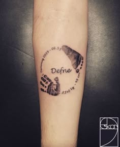 a hand and foot print with the words defre written in black ink on a person's arm