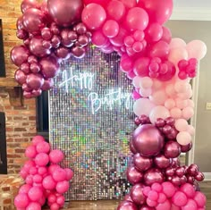 a bunch of balloons that are in front of a birthday sign with the words happy birthday written on it