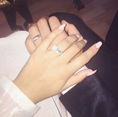 a woman's hand with two rings on it