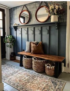 a bench with baskets on it in front of a mirror and two mirrors above it