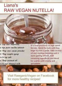 a jar filled with peanut butter next to almonds on top of a wooden table