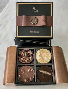 an open box with four different chocolates in it