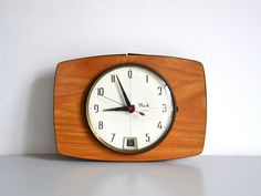 a small wooden clock sitting on top of a table