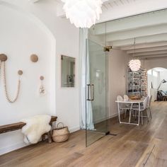 the interior of a house with wood floors and white walls, including a large glass door