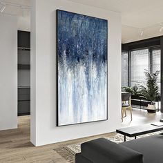 an abstract painting hangs in the living room