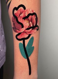 a woman's arm with a flower tattoo on it