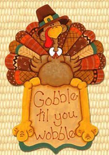 a turkey holding a sign that says gobble fill you wobble