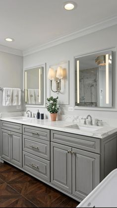 a large bathroom with two sinks and mirrors