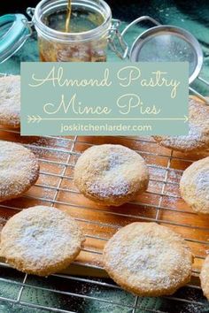 powdered sugar cookies cooling on a wire rack with jar of jam in the background