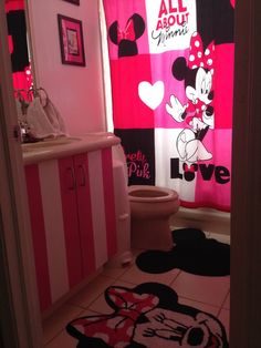 a bathroom decorated in pink and black with minnie mouse shower curtain