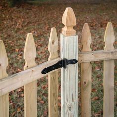 a wooden fence with a black handle on it