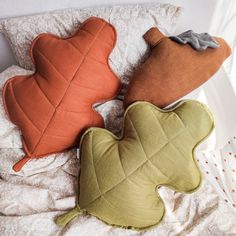 three pillows are laying on top of each other