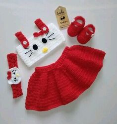 a crocheted hello kitty outfit and booties is shown with its matching accessories