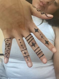 a woman with tattoos on her hands and fingers