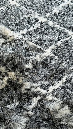 an area rug with black and white designs on it's surface, close up