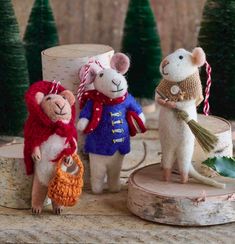 three little mice are dressed in sweaters and hats