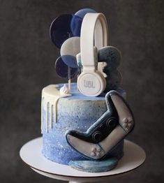 a blue and white cake with headphones on top