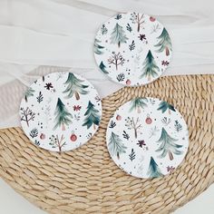 three plates sitting on top of a wicker basket next to a white table cloth