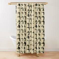 a shower curtain with black and white silhouettes of birds on beige background, in front of a bathtub