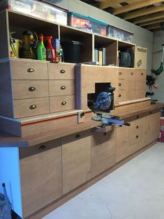 a garage with lots of cabinets and tools in it's storage area on the wall