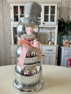 a disco ball snowman sitting on top of a table