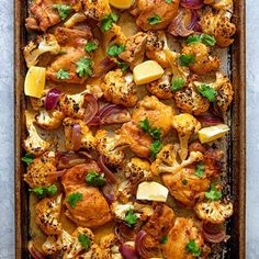 roasted cauliflower and onions with parsley in a baking pan on a table