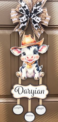 a cow wearing a cowboy hat and holding a sign that says dariyan on it