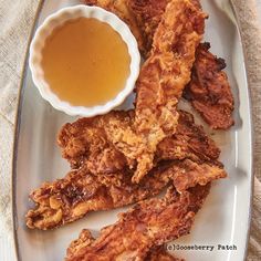 fried chicken and dipping sauce on a white plate