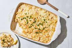 a casserole dish with chicken and vegetables in it next to a bowl of macaroni and cheese