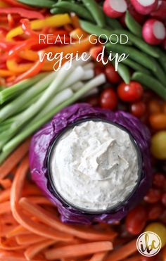 a bowl of dip surrounded by vegetables and carrots with the words really good veggie dip above it