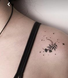 a woman's back with stars and a crescent tattoo on her left side shoulder