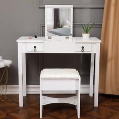 a white dressing table with stool and mirror