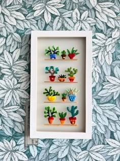 a shadow box with some fake plants in it