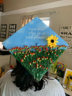 a woman wearing a graduation cap decorated with flowers