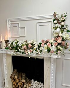 the fireplace is decorated with flowers and logs