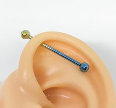 an ear piercing device attached to a fake human head