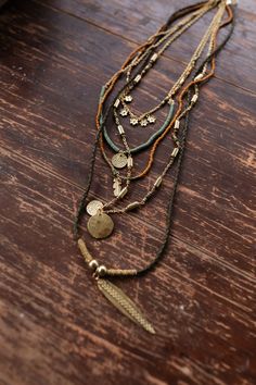 Perfect for the expressive soul the Odessa Necklace is a boho gals dream! You'll love finishing your look with this boho statement piece because it features: Long necklace style with 5 unique layers Mixed layers of rope and chains So cute mix of green, orange, and gold beads with gold pendants of flowers, feathers, and circles Classic lobster claw closure with a 2" extender *Due to lighting and differences in monitors, actual colors may vary slightly from what appears online. Model is 5'8" and w Witchy Boho Jewelry, Bohemian Jewellery Necklaces, Boho Crystal Jewelry, Make Your Own Jewelry Necklaces, Interesting Jewelry Designs, Wedding Jewelry Boho, Boho Jewelry Necklaces, Boho Necklace Outfit, Hippie Jewelry Aesthetic