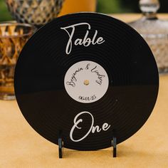 a table with a black record on it that says table one and the name of the couple