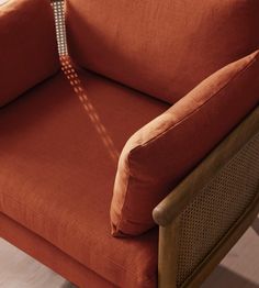 an orange chair sitting on top of a hard wood floor