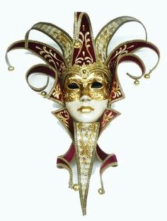 a masquerade mask is shown on a white background with red and gold details