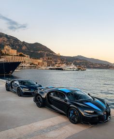 three bugatti cars parked next to each other on the side of a body of water