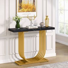 a black and gold console table in a white room