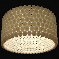 a lamp that is made out of white circles and lightshades on the ceiling