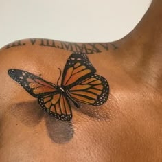 a man with a butterfly tattoo on his chest